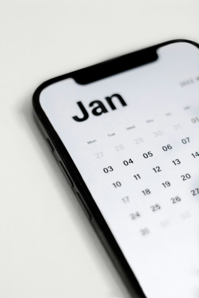 A phone with a calendar showing on the month of January